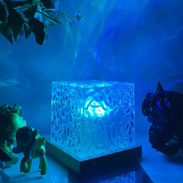 Ocean wave lamp with color-changing LEDs, creating a calming ambiance on a desk with various decorations